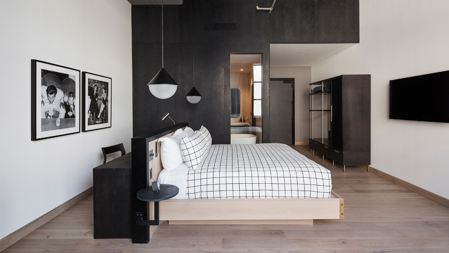 A hotel suite featuring grid printed linens and modern decor